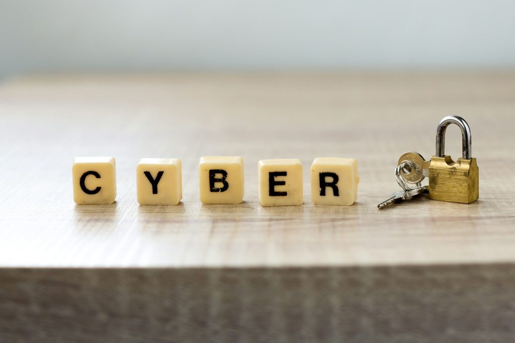 Cyber lettering with padlock on wooden table
